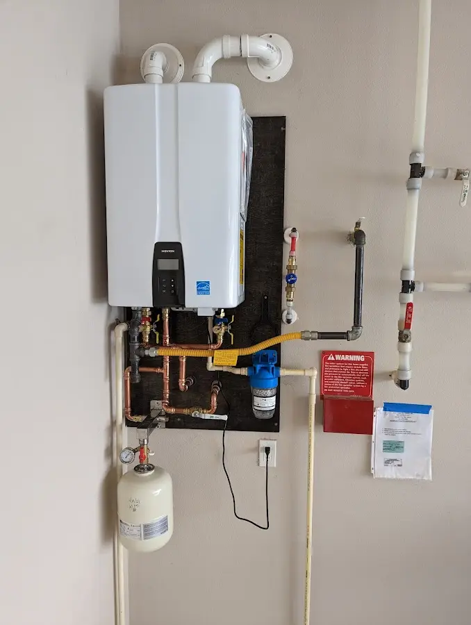 Professional plumber installing copper piping in a Ida home